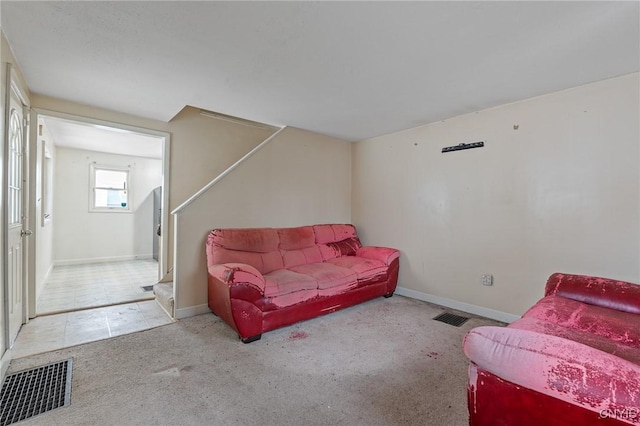 living room featuring baseboards, visible vents, and light colored carpet