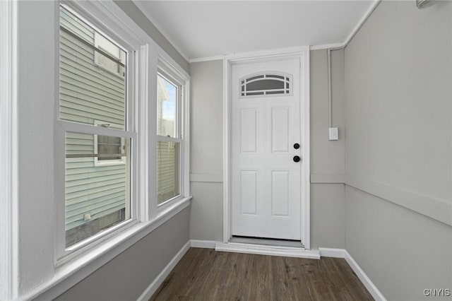 doorway to outside with dark wood-style floors and baseboards