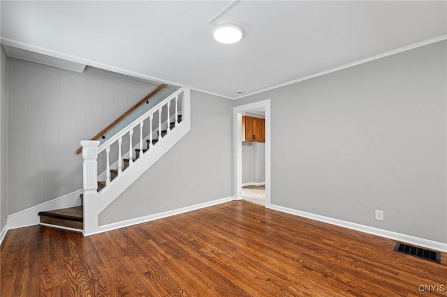 interior space with wood finished floors, visible vents, baseboards, stairway, and crown molding