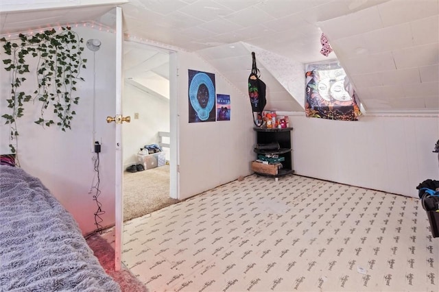 interior space featuring lofted ceiling and carpet flooring