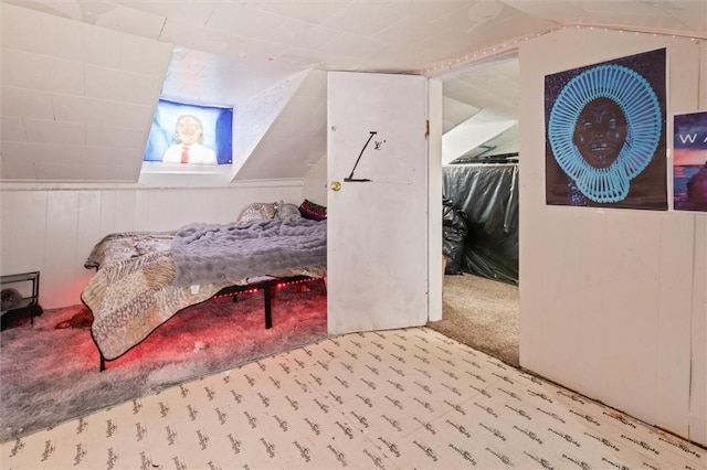 bedroom featuring wood walls and light colored carpet