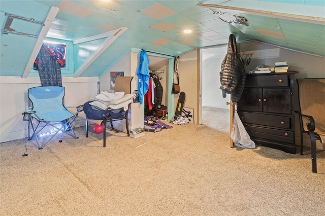 interior space featuring vaulted ceiling and carpet flooring