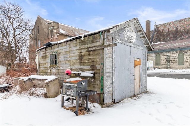 snow covered structure with an outdoor structure