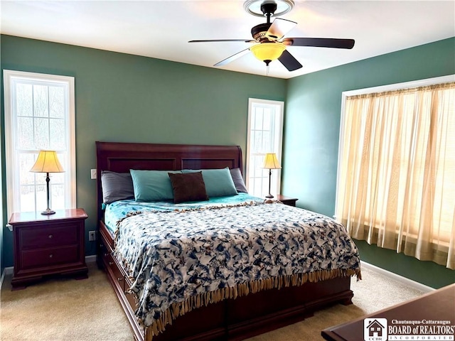 carpeted bedroom with baseboards and ceiling fan