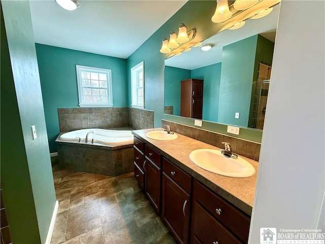 bathroom featuring a garden tub, an enclosed shower, double vanity, and a sink