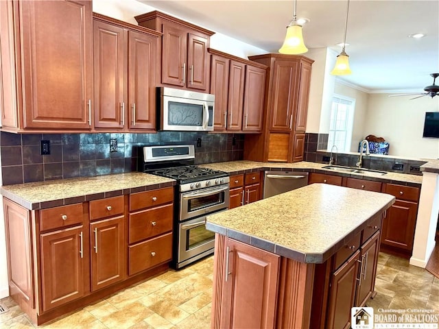 kitchen with tasteful backsplash, appliances with stainless steel finishes, a peninsula, and a sink