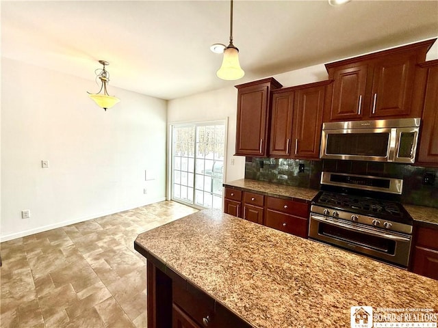 kitchen featuring decorative backsplash, baseboards, appliances with stainless steel finishes, and pendant lighting