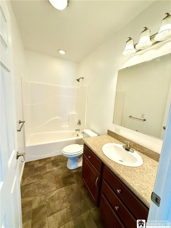 full bath featuring tub / shower combination, toilet, and vanity