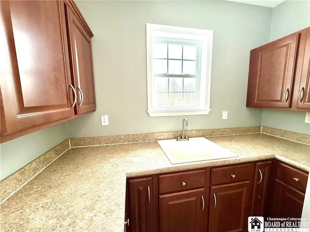 kitchen featuring light countertops and a sink