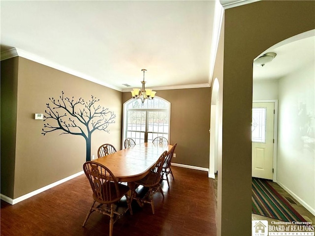 dining room featuring a wealth of natural light, arched walkways, wood finished floors, and ornamental molding