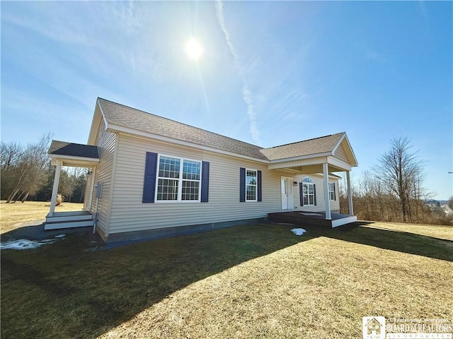 view of front of house with covered porch and a front yard