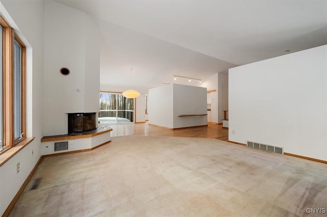 unfurnished living room with light colored carpet and visible vents