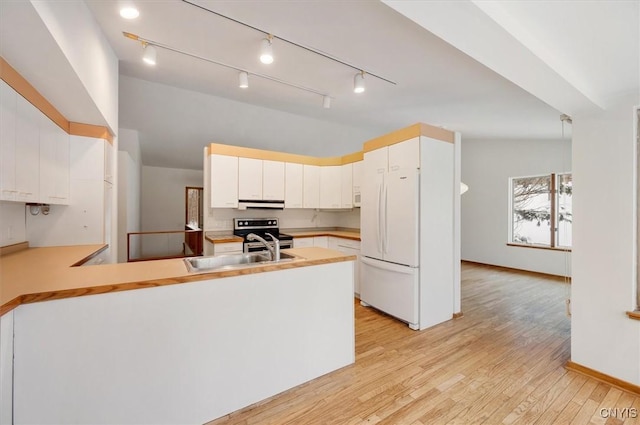 kitchen with electric range, a sink, white cabinetry, light wood-style floors, and light countertops