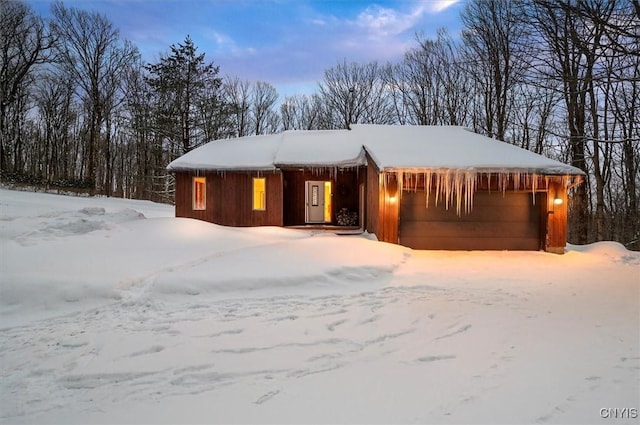 chalet / cabin with an attached garage