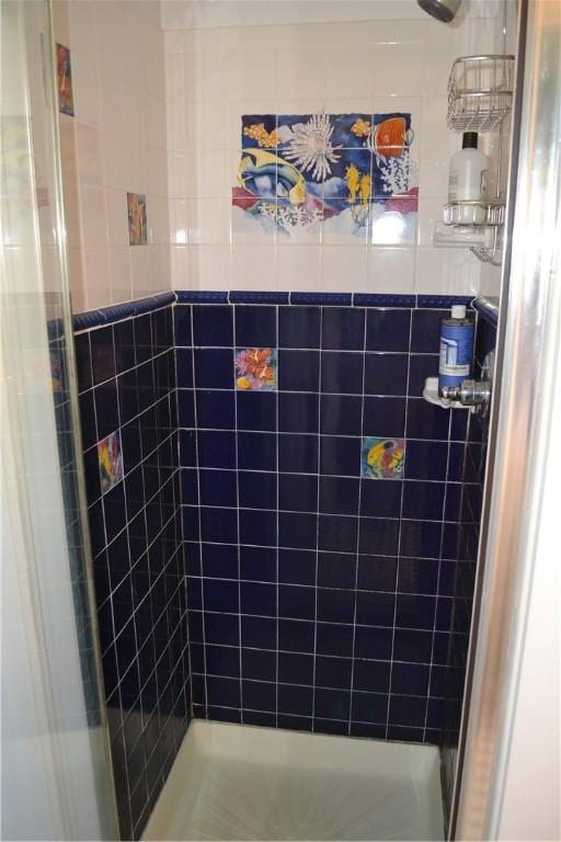 bathroom featuring a shower stall