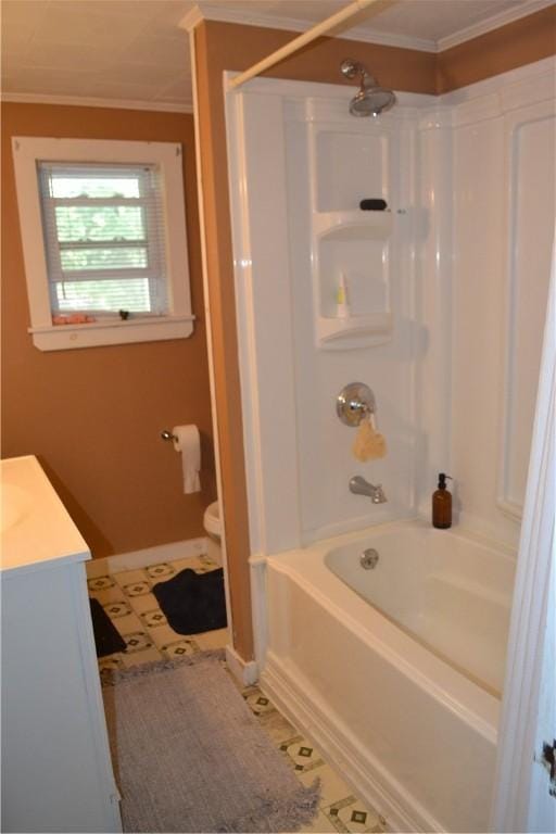 bathroom featuring crown molding, bathtub / shower combination, toilet, vanity, and tile patterned flooring