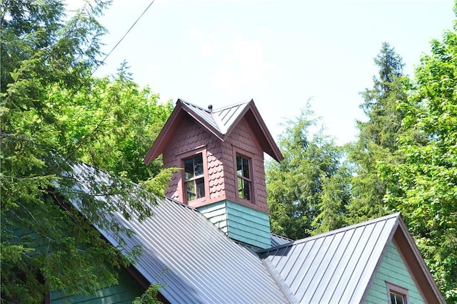 view of side of property with a standing seam roof and metal roof