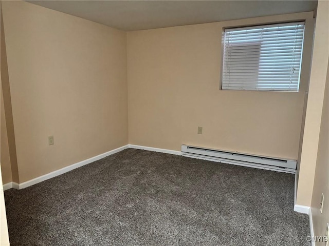 spare room featuring dark carpet, a baseboard radiator, and baseboards