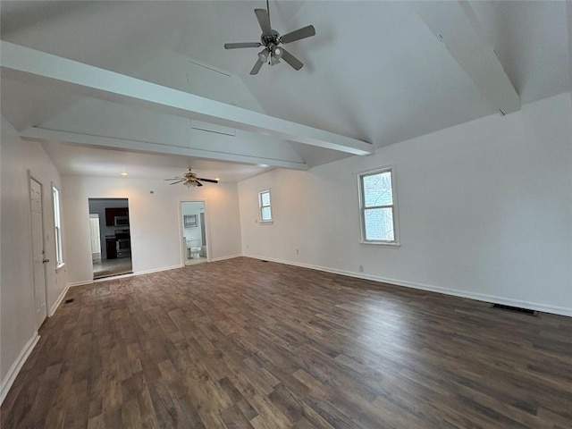 spare room with vaulted ceiling with beams, baseboards, visible vents, and dark wood finished floors