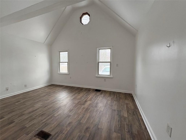 empty room with baseboards, dark wood finished floors, visible vents, and a healthy amount of sunlight