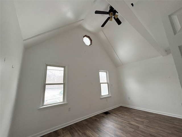 empty room featuring high vaulted ceiling, dark wood-style flooring, a ceiling fan, visible vents, and baseboards