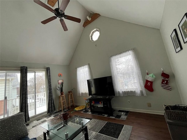 living area featuring ceiling fan, high vaulted ceiling, wood finished floors, and baseboards