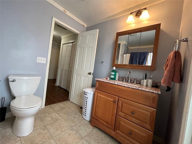 full bath featuring toilet, baseboards, and vanity