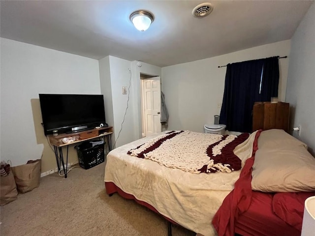 bedroom featuring visible vents and light colored carpet