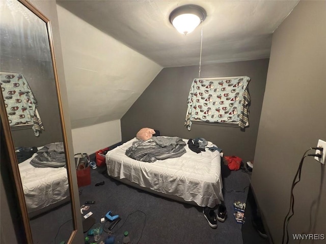 carpeted bedroom with vaulted ceiling and a closet