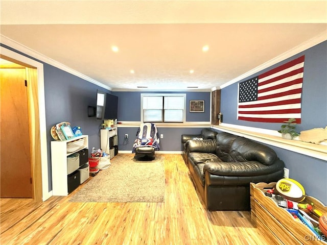 playroom featuring light wood-style floors, baseboards, and ornamental molding