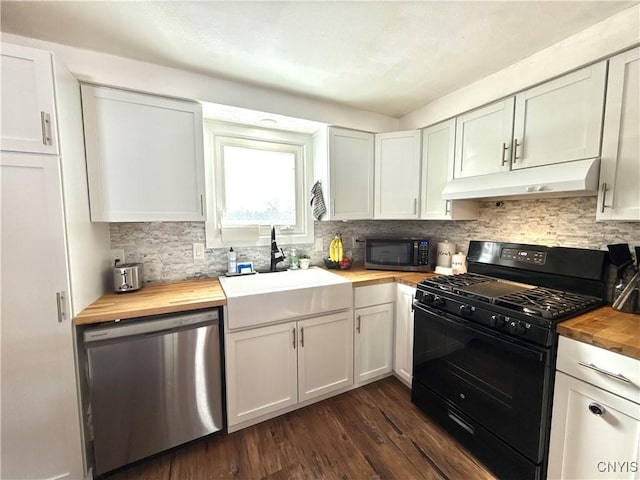 kitchen with white cabinets, wood counters, stainless steel appliances, under cabinet range hood, and a sink