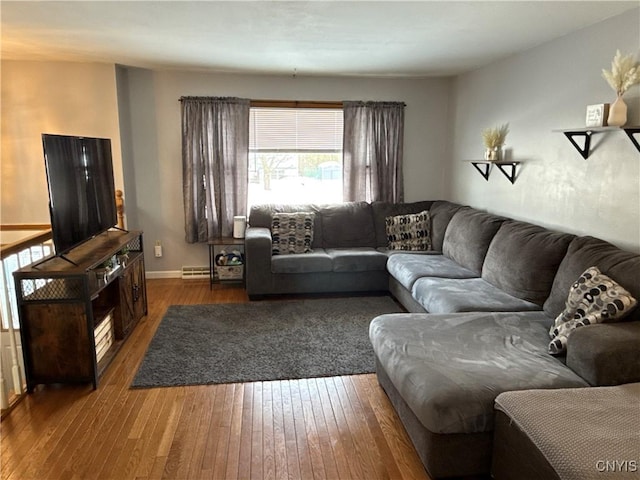 living room with dark wood-style floors, visible vents, and baseboards