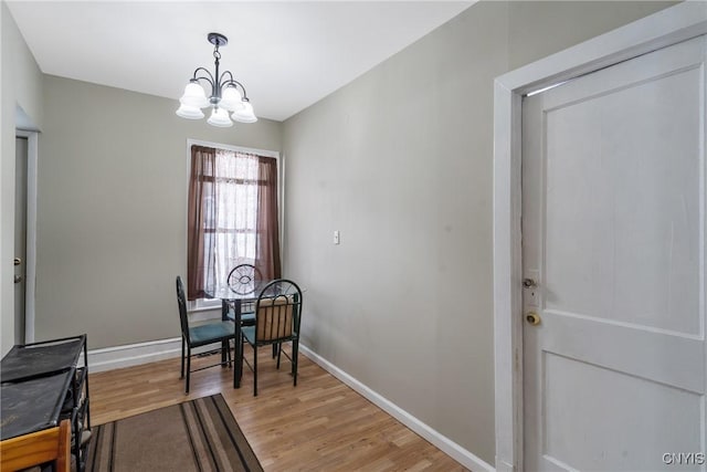 213 Salisbury St, Sandy Creek, NY 13145 - dining room with an inviting chandelier, baseboards, and light wood-style flooring