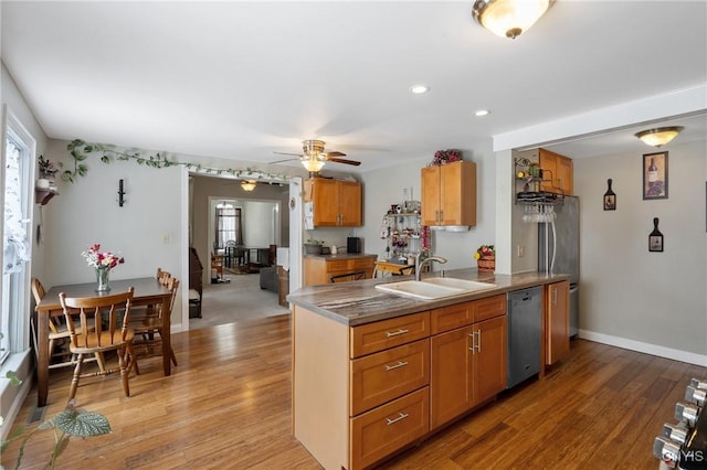 213 Salisbury St, Sandy Creek, NY 13145 - kitchen featuring ceiling fan, stainless steel dishwasher, brown cabinets, a sink, and light wood finished floors