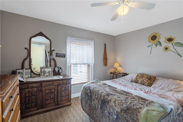 bedroom with a ceiling fan and baseboards