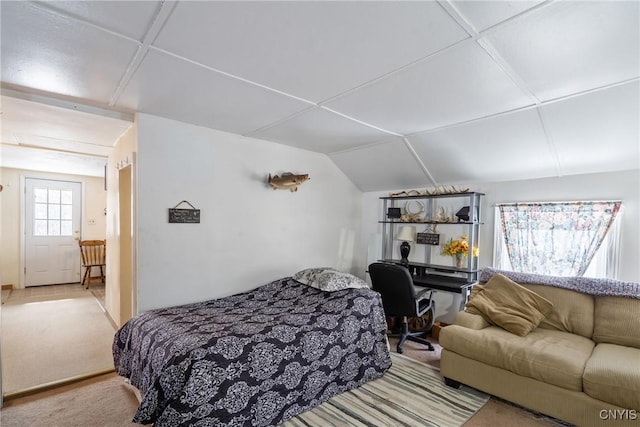 bedroom with lofted ceiling and light carpet