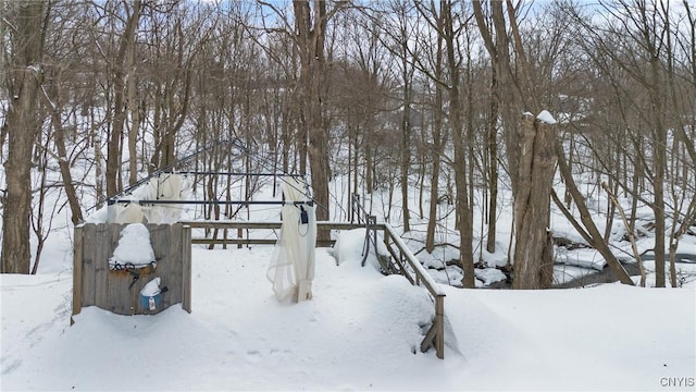 yard layered in snow featuring a garage