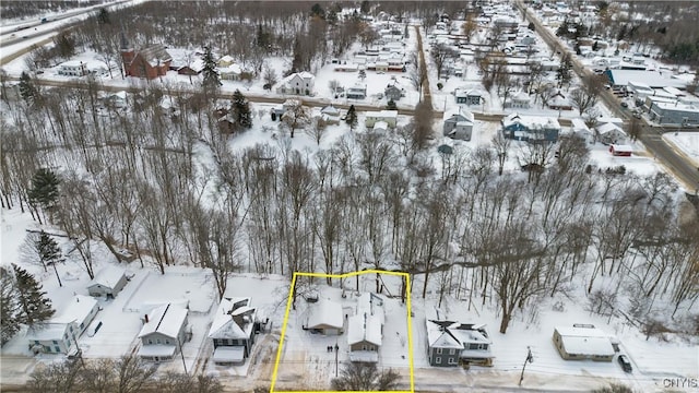 snowy aerial view featuring a residential view