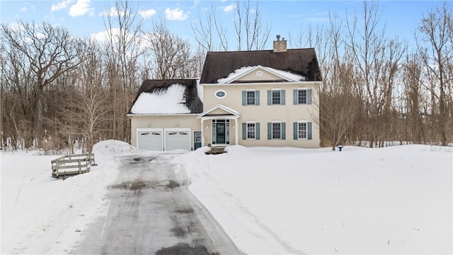 view of front of house featuring a garage and a chimney