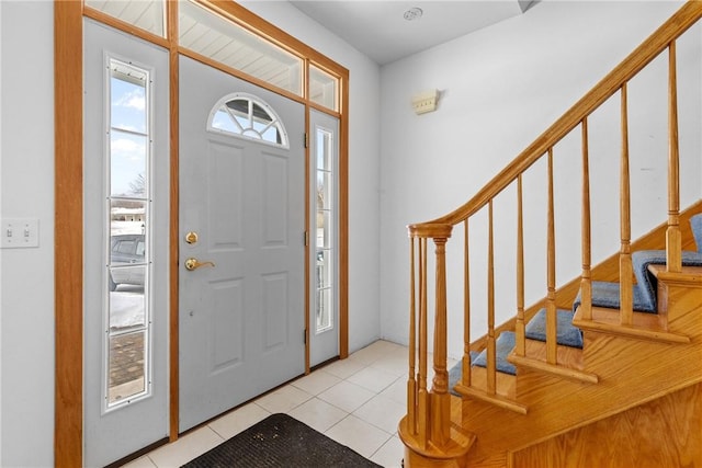 foyer with stairs and light tile patterned flooring