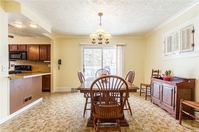 dining room with an inviting chandelier, baseboards, and visible vents