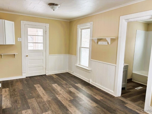 interior space with ornamental molding, dark wood-style flooring, and wainscoting