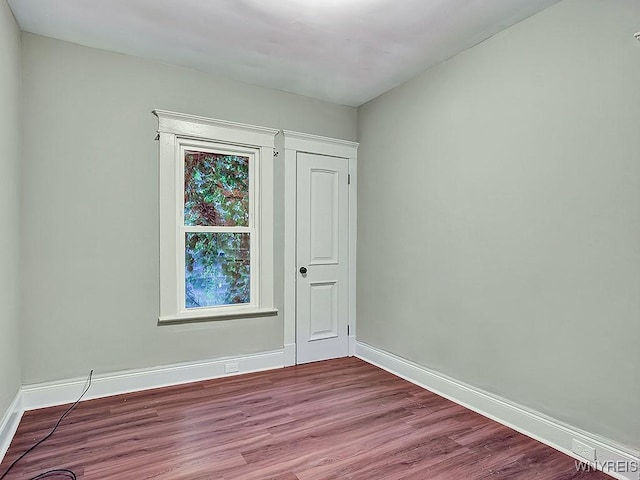 unfurnished room featuring light wood-style floors and baseboards