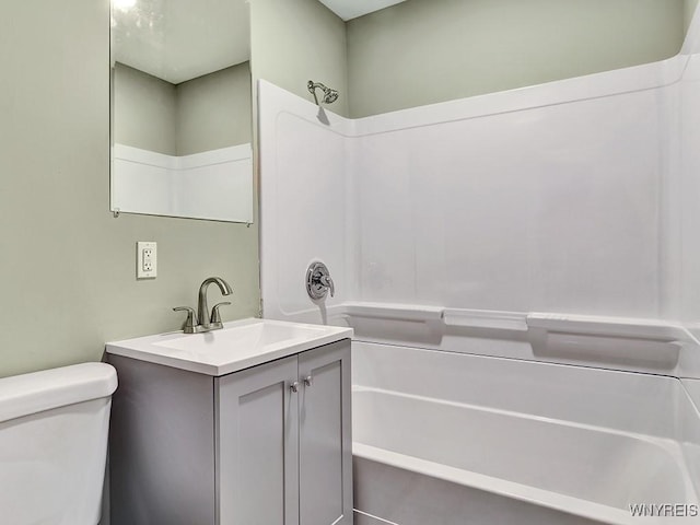 bathroom featuring shower / bathtub combination, vanity, and toilet