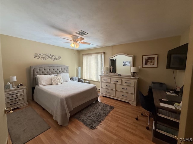 bedroom with light wood-type flooring, ceiling fan, and visible vents