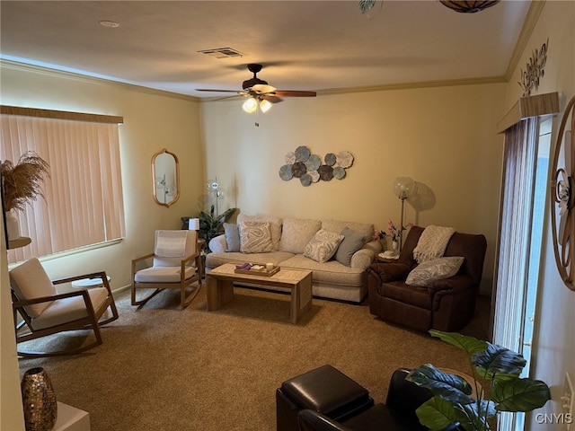 living room with ornamental molding, carpet, visible vents, and a ceiling fan