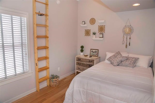 bedroom featuring recessed lighting, light wood-style flooring, and baseboards