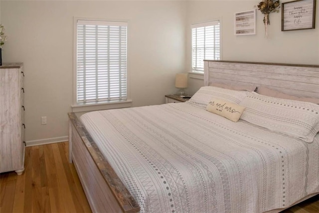 bedroom featuring wood finished floors and baseboards