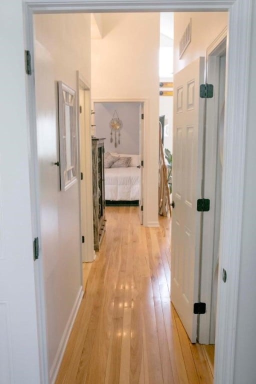 corridor featuring visible vents and light wood-style flooring