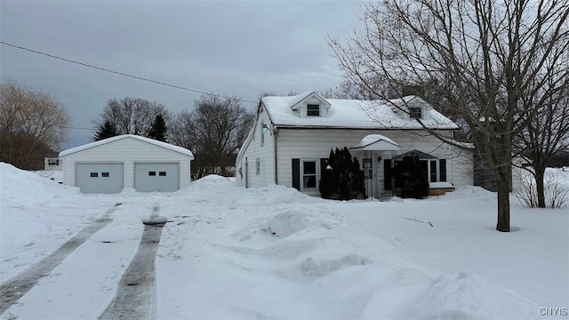 view of snow covered exterior with a garage and an outdoor structure